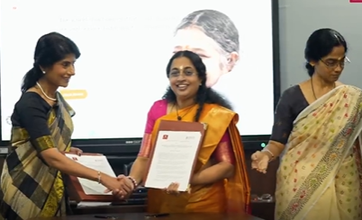 Three women celebrating Amrita Center signing